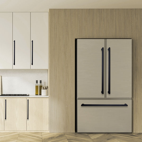 Modern kitchen with light wood cabinets, a built-in refrigerator with black handles, and a vertical wood panel accent wall. Two bottles and a small container sit on the white countertop.