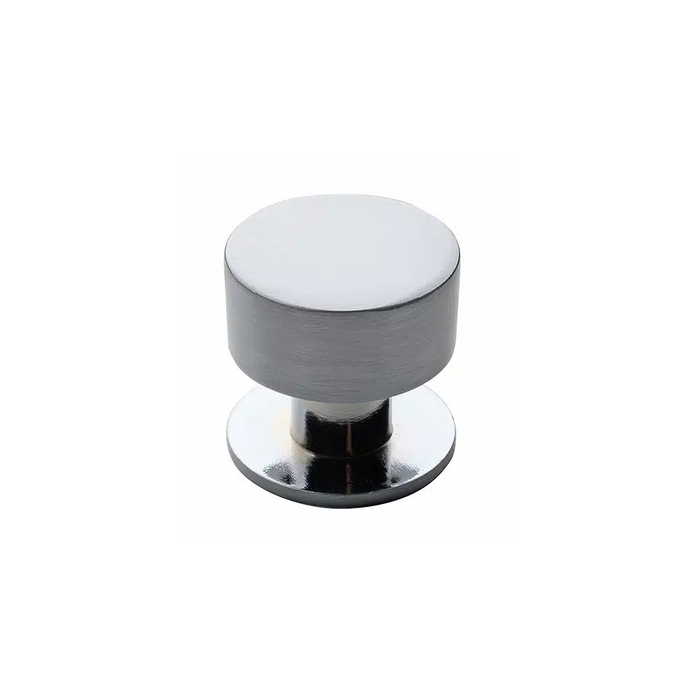 A round, silver Zinc Die-Cast cabinet knob by Taymor Industries features a brushed finish and small circular base, displayed against a plain white background.