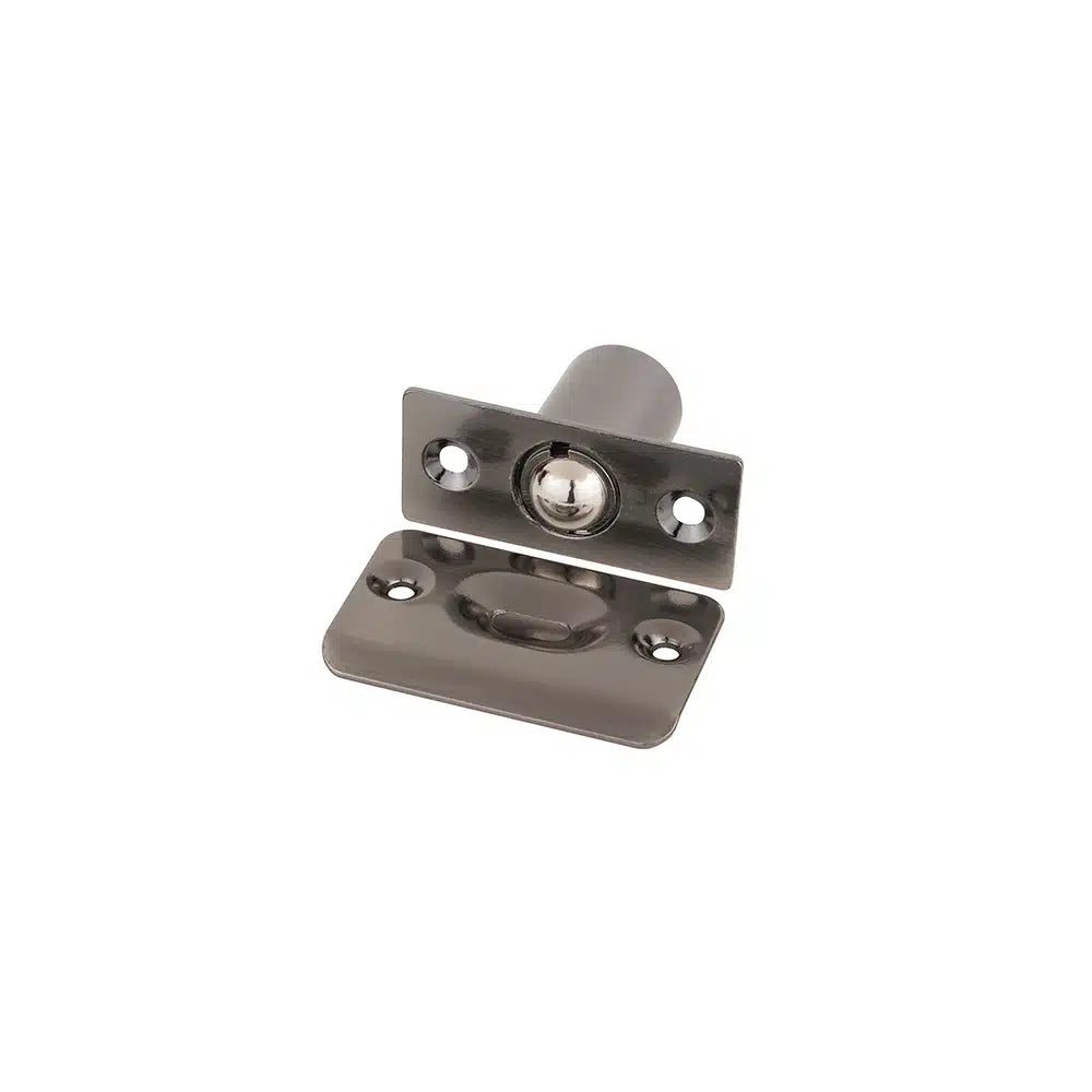 The Taymor Industries metal door ball catch features a zinc die-cast body, a rectangular stamped steel strike plate, and a spring-loaded ball to hold doors closed without a latch.