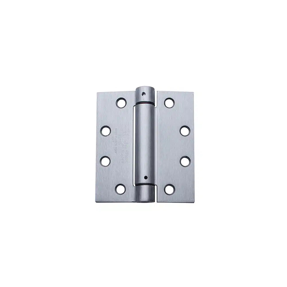 A Taymor Industries stainless steel adjustable spring hinge features six screw holes per plate, a central cylindrical barrel, meets ANSI specs, and is shown on a white background. Ships from Canada.
