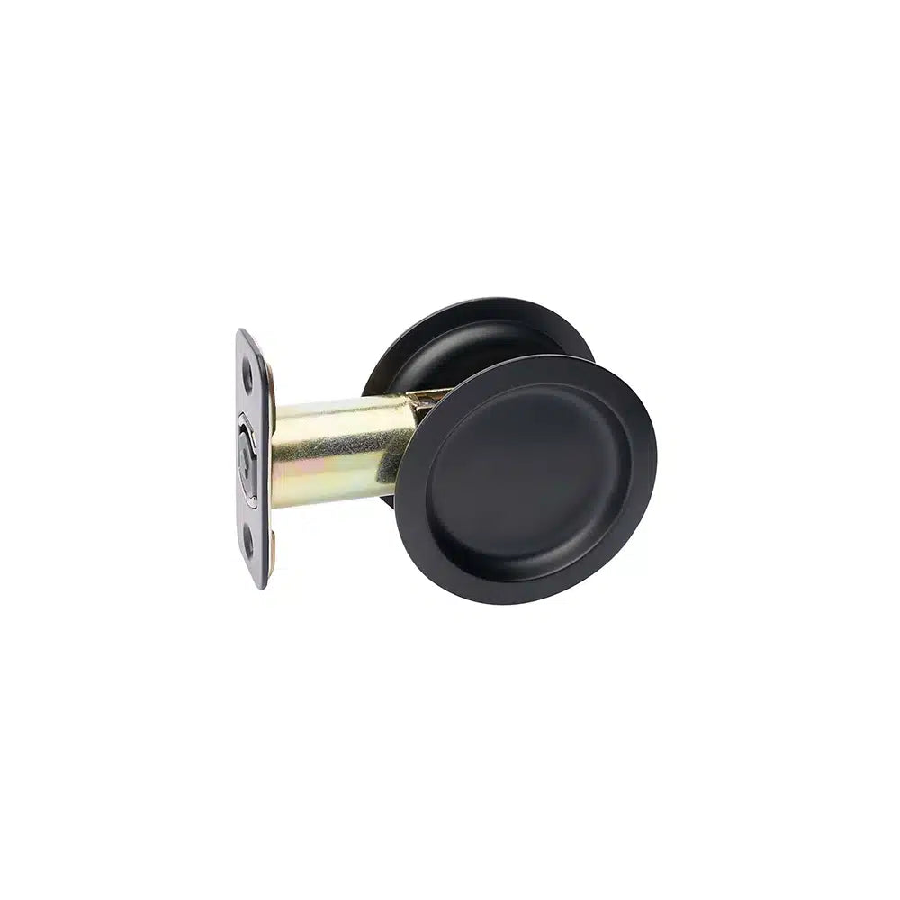 Taymor Industries black round pocket door handle with recessed grip, metal mounting plate, latch face plate, and reversible lock, shown isolated on a white background.