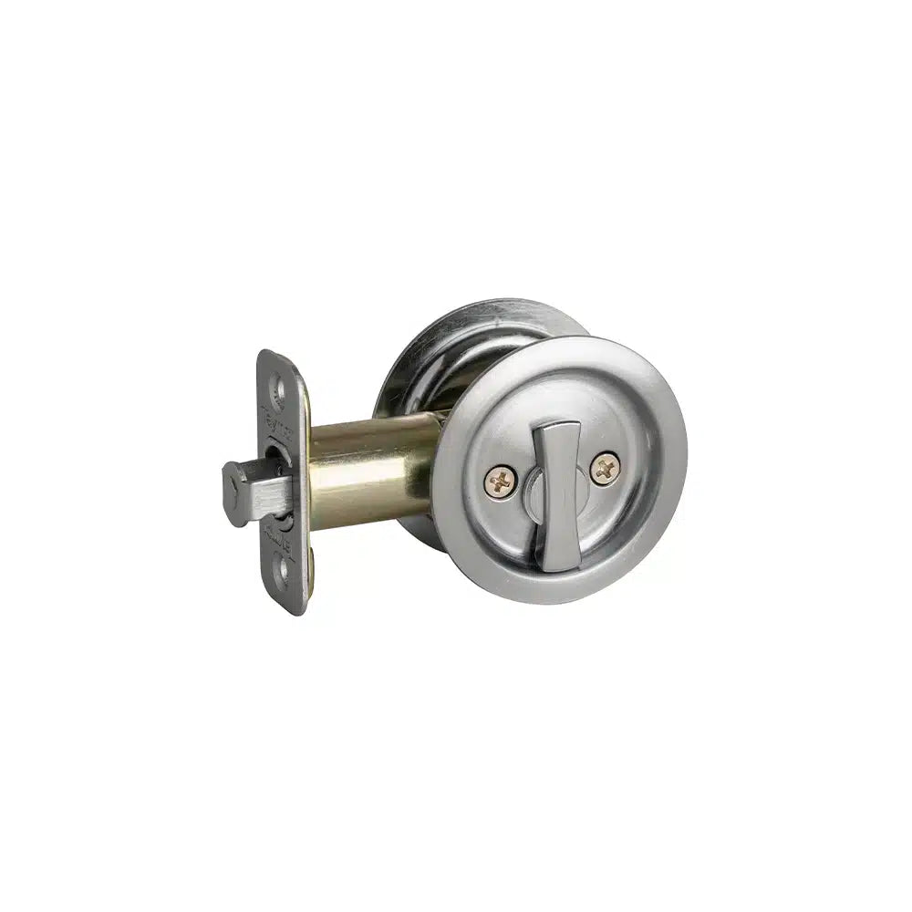A round, silver pocket door lock by Taymor Industries features a turn lever and a rectangular radius corner latch face plate on one side, designed for sliding doors.