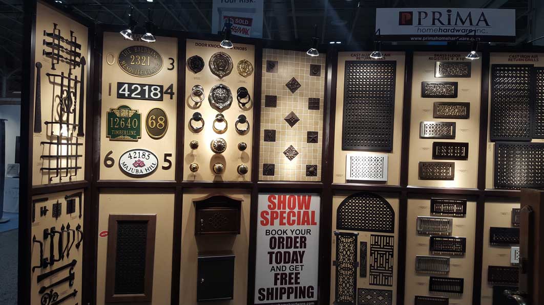 A wall with signs and door knockers.