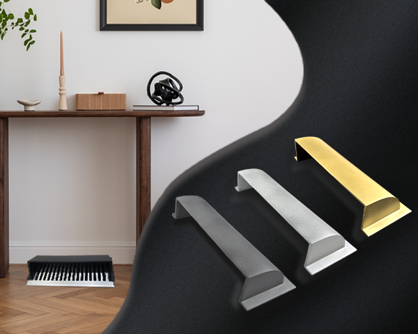 Three modern cabinet handles in silver and gold are displayed on a black background. Behind them, a stylish room features a wooden console table, decor items, a framed picture, and a keyboard on the floor.