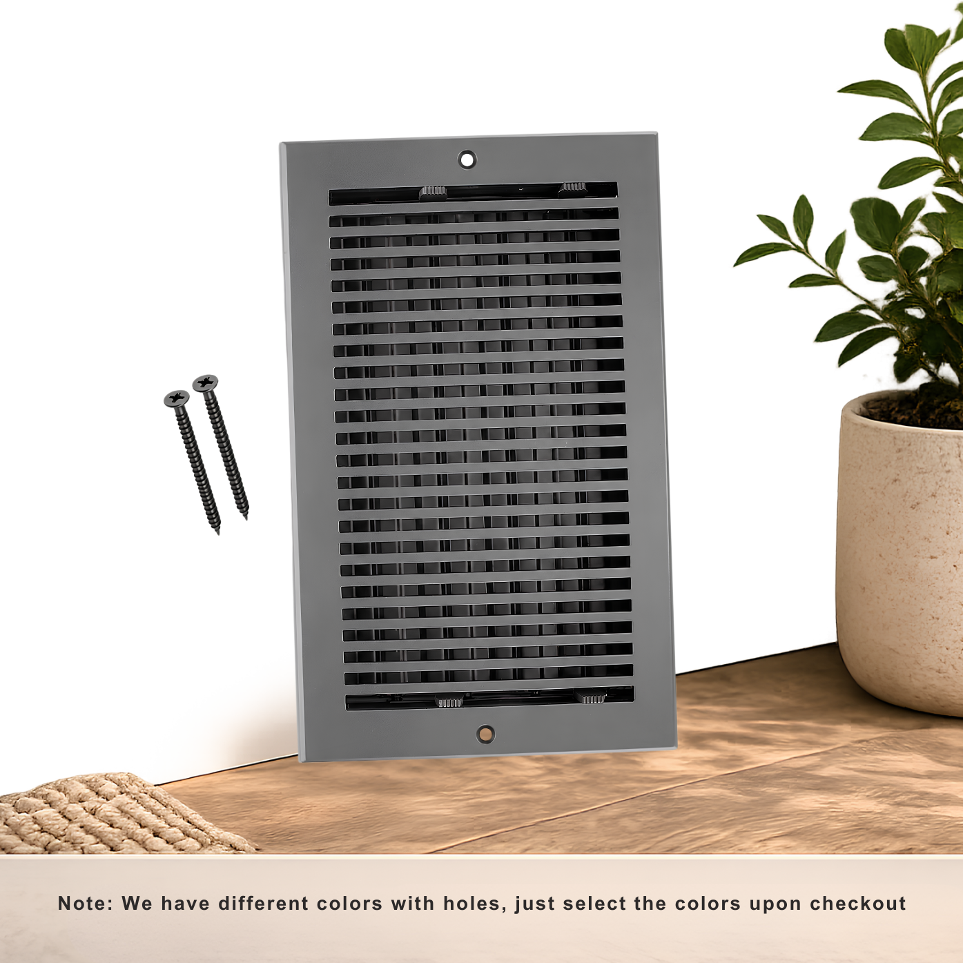 Decorative wall vent on a wooden floor with a plant and screws nearby