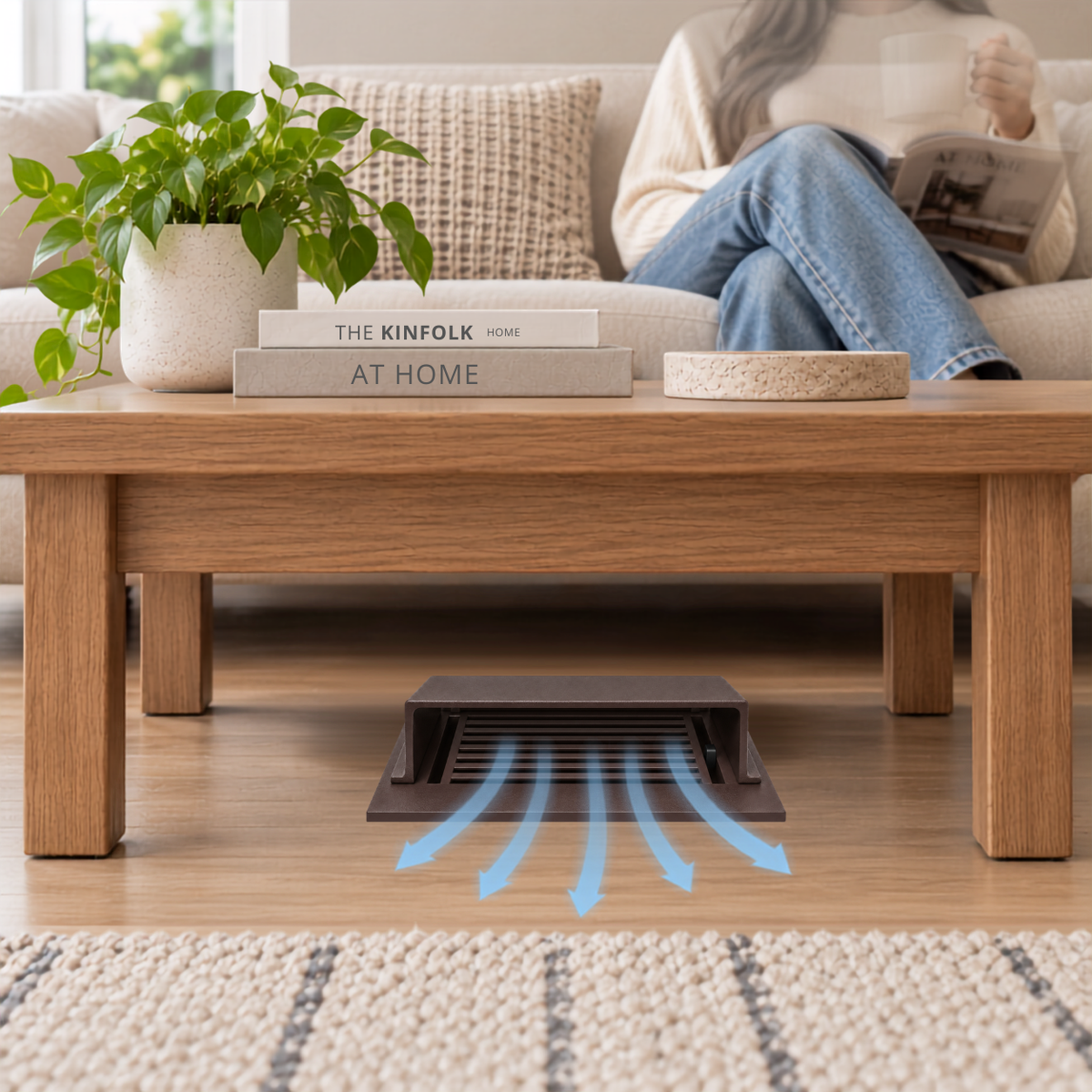A brown deflector installed on a wooden floor beneath a wooden coffee table in a modern living room.
