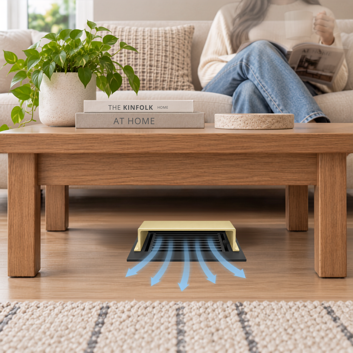 A gold deflector installed on a wooden floor beneath a wooden coffee table in a modern living room.

