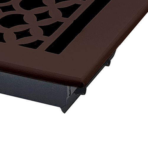 Close-up of a Prima Decorative Hardware vent cover with a Tudor Mushroom design, crafted from dark brown cast aluminum. Features geometric circular and rectangular cutouts, partially shown against a white background.