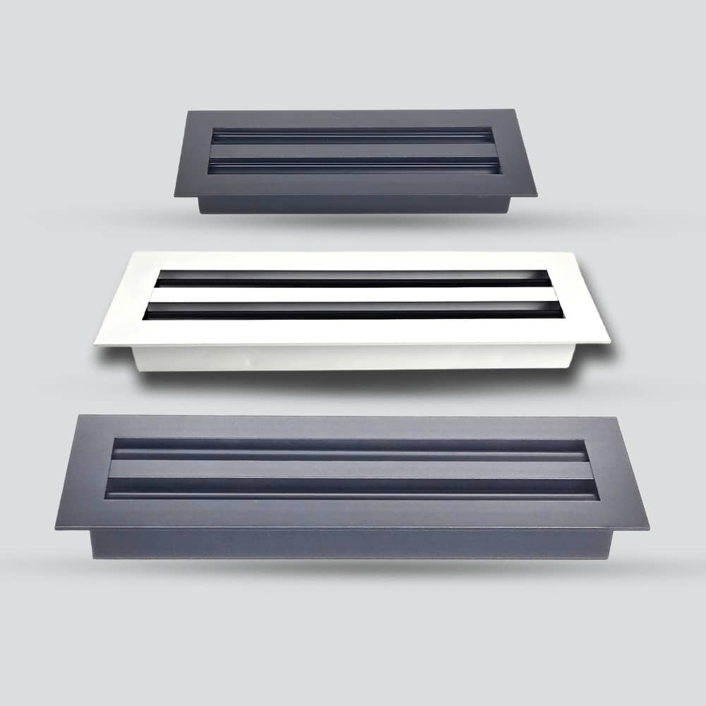 Three rectangular air vents with horizontal slats, shown in black, white, and gray, arranged in a staggered formation on a light gray background.